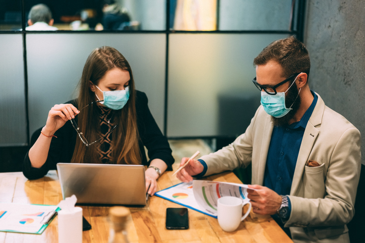 man and woman in masks