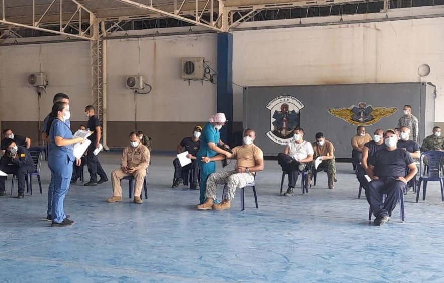 Rapid Response Team members (standing, left) assist with the COVID-19 vaccination process in Barranquilla, Colombia