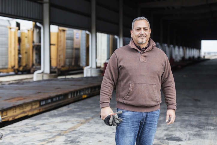 Manual worker standing outdoors at shipping port