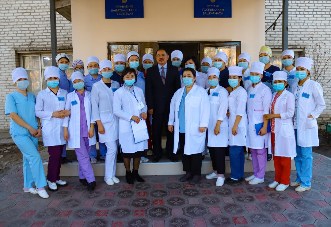 Nurses who participated in training for the universal nurse role gather with Dr. Toktobay Maanaev (center), head of the Kyrgyzstan National Hospital. In the front row, fifth from left, is Tolkun Kayipova, the Nursing Development Center specialist who conducted the training.