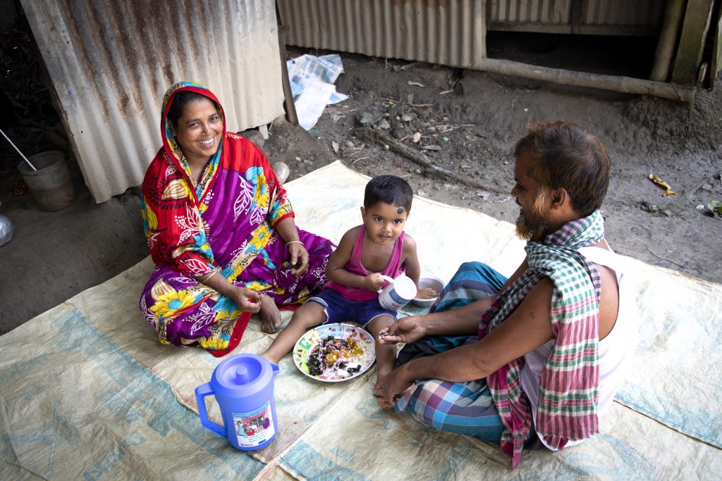 Feroza Begum feeding home-grown vegetables to her grandson. Image credit: Tareq Salahuddin/USAID FTF BNA