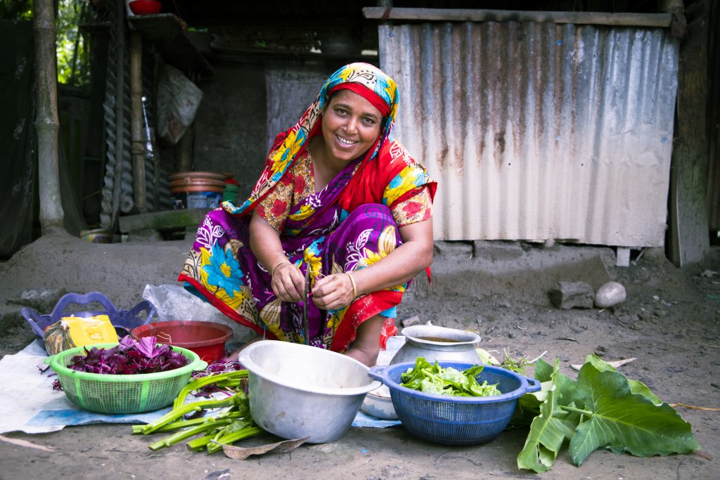 Feroza Begum is preparing vegetables from her homestead garden for cooking. Image credit: Tareq Salahuddin/USAID FTF BNA