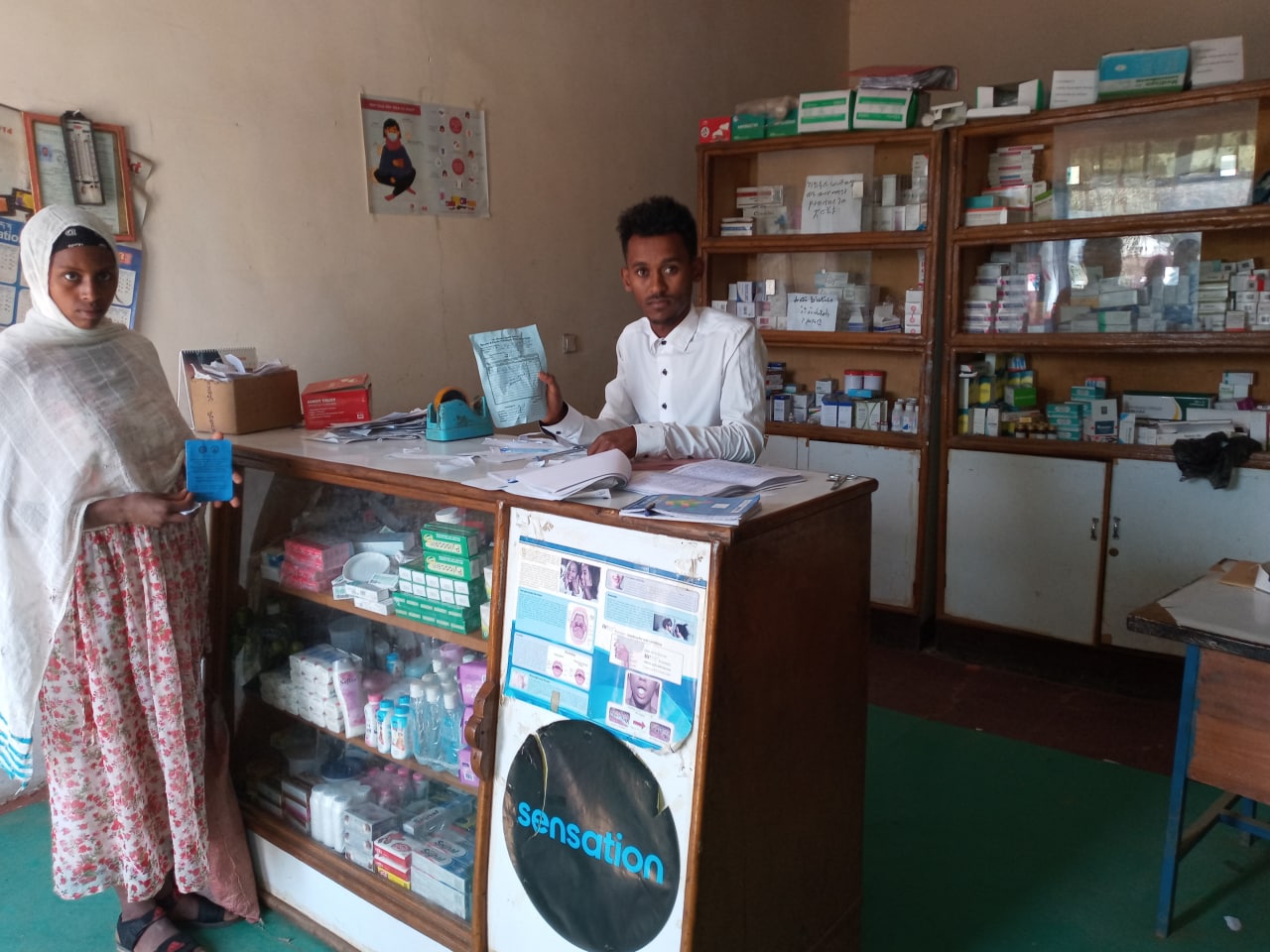 A CBHI participant gets her prescriptions at Asfaw Norahun Drug Store. Photo credit: Abay Akalu