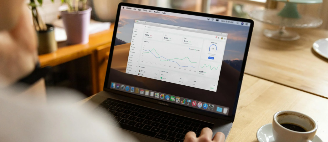 Laptop sitting on a desk showing graphs and data