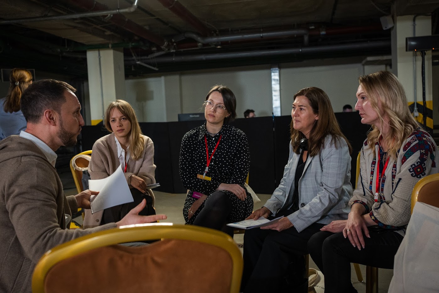Men and women sitting in a circle having a serious discussion