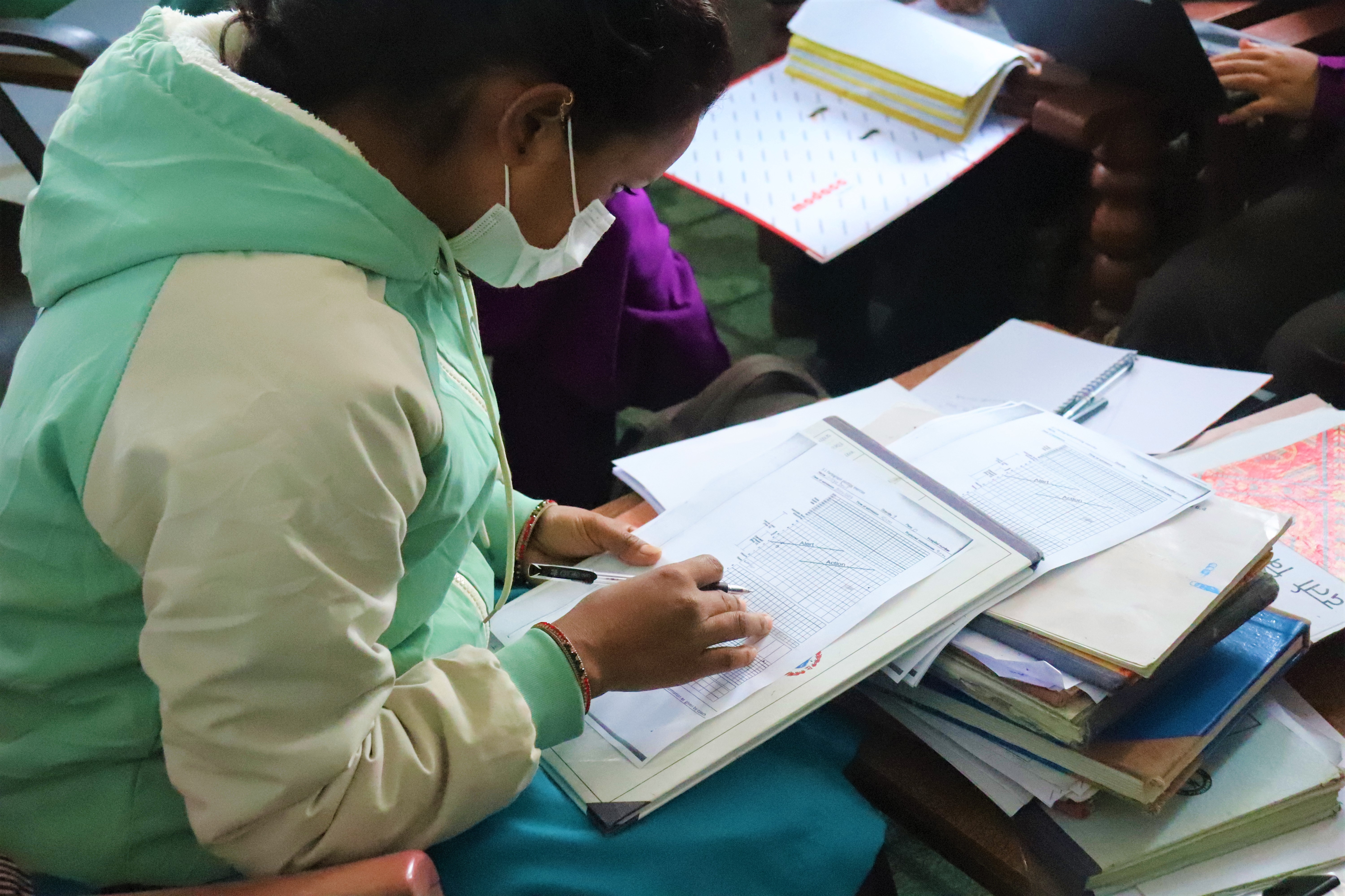 Nepalese woman writing in a classroom