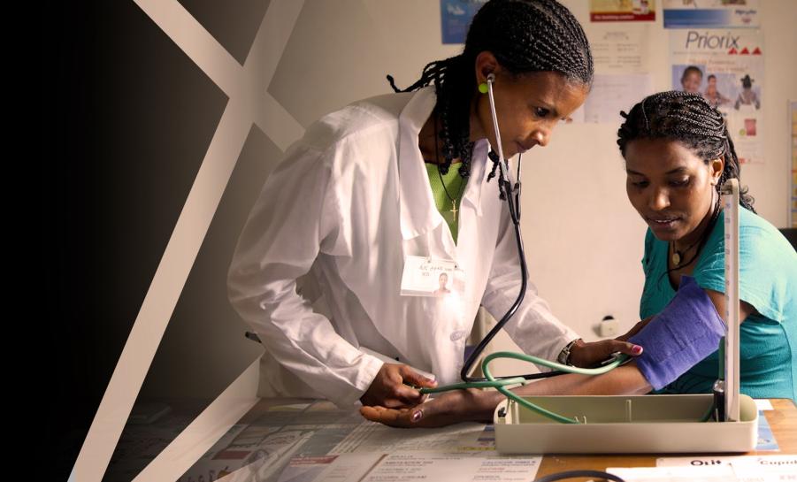 doctor using stethoscope to listen to patient's pulse