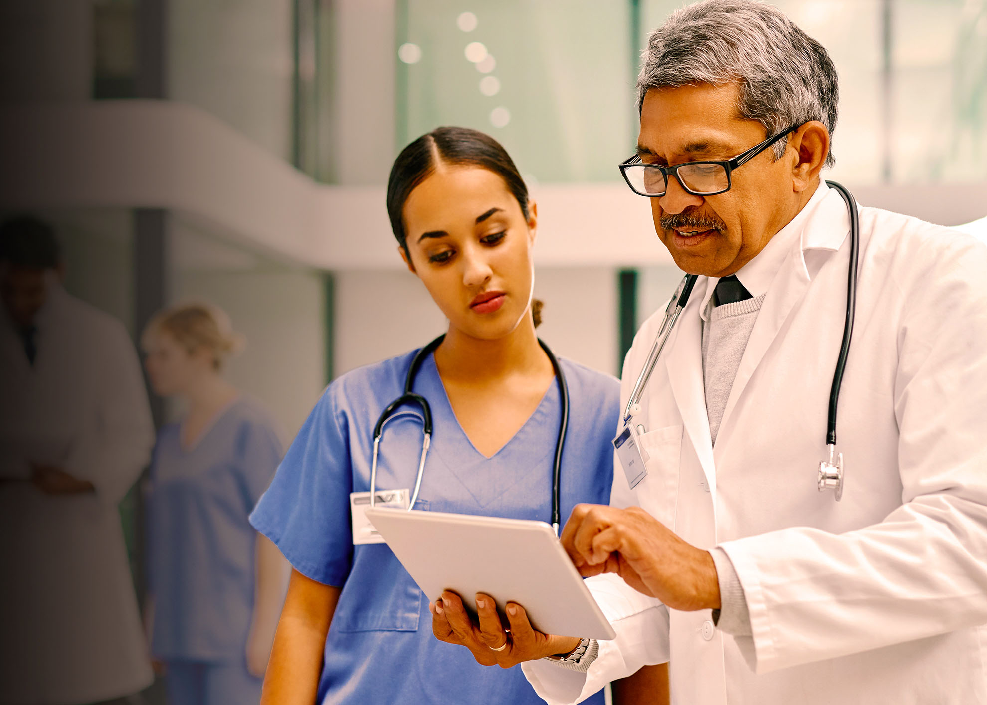 two doctors discussing information on a medical chart