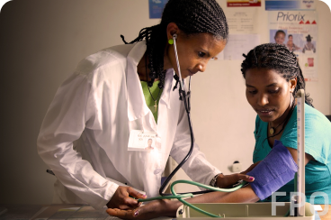 doctor taking patients blood pressure