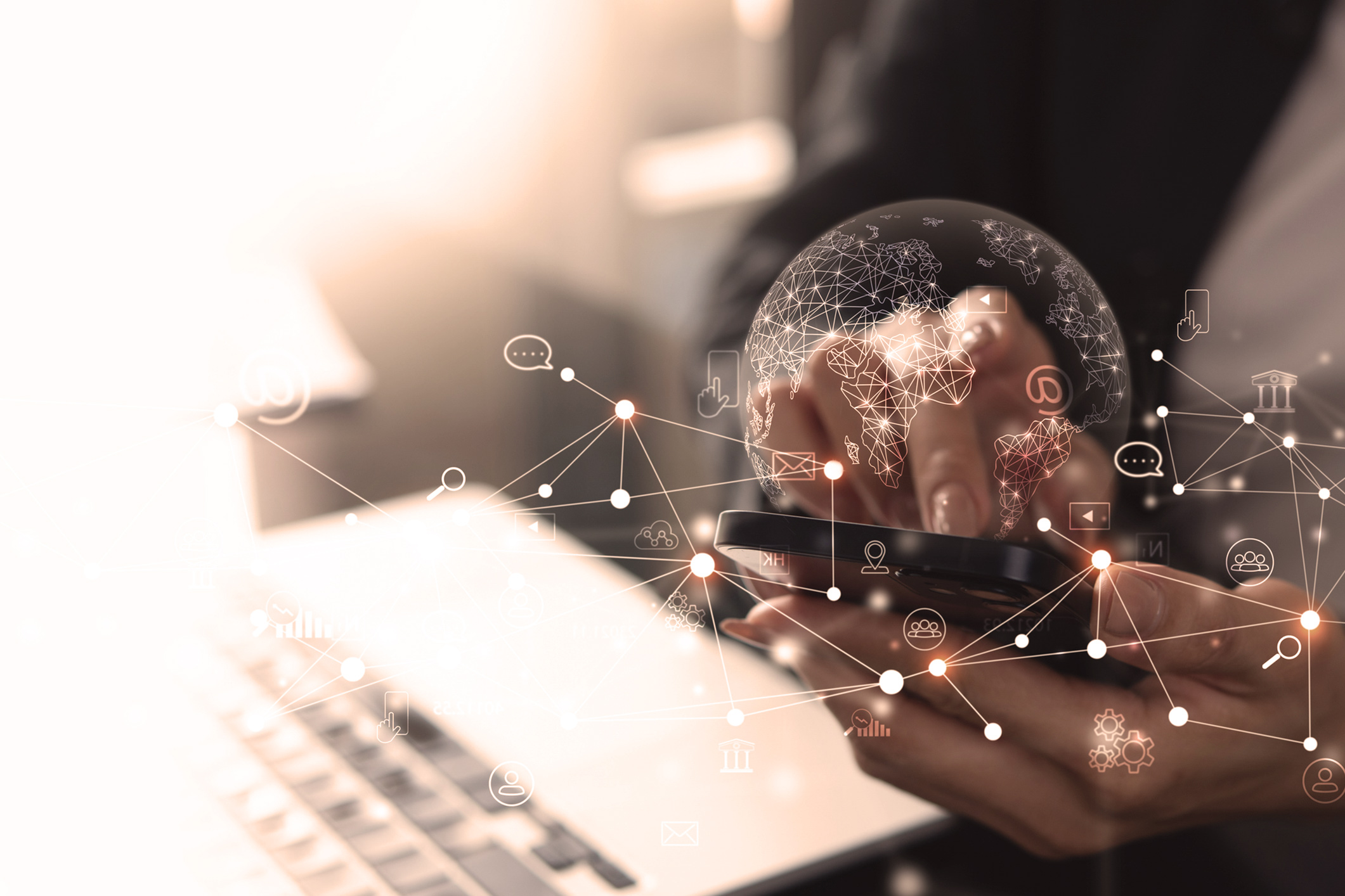 hands at a keyboard with digital graphics floating in front of them