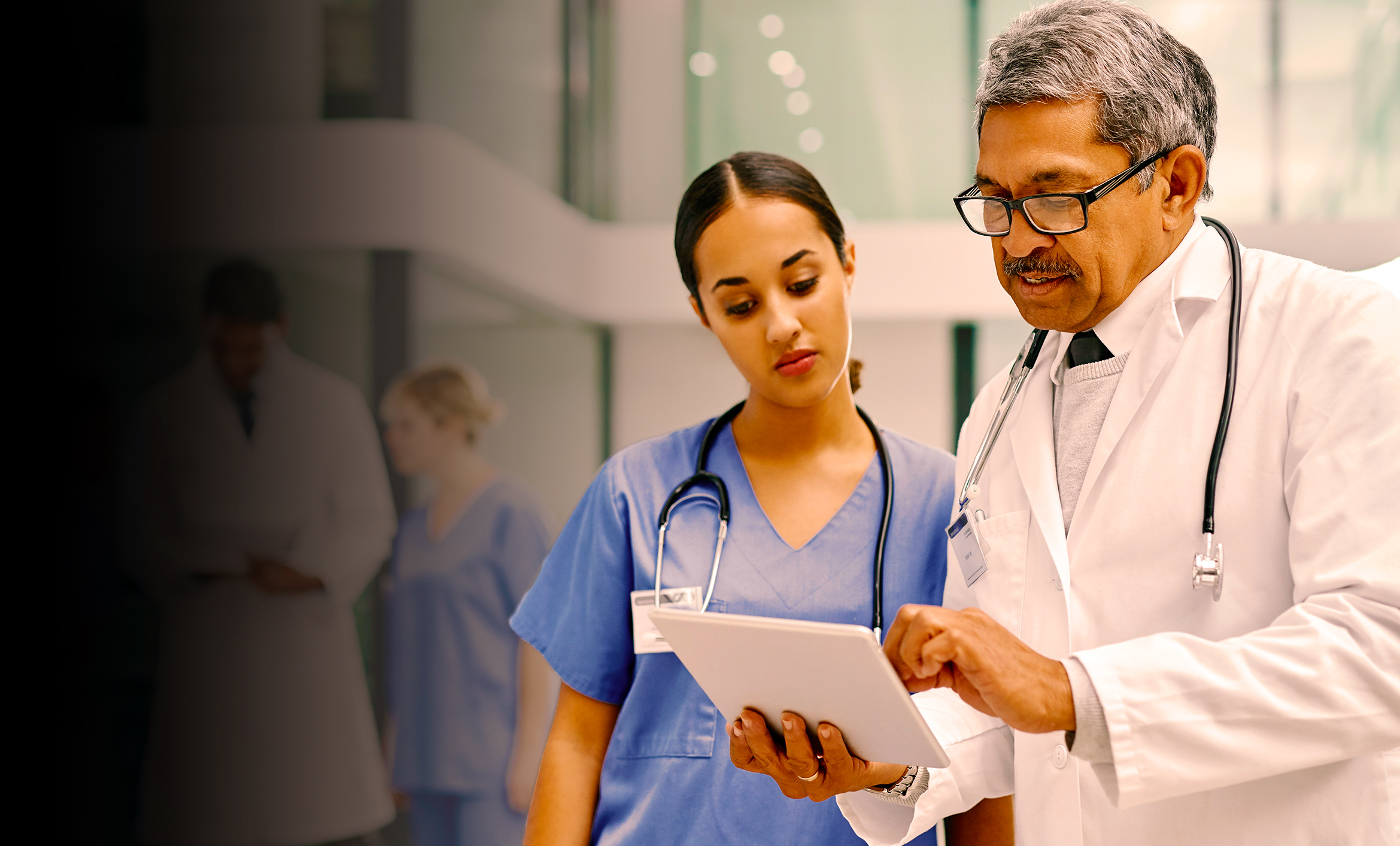 Two doctors discussing information on a chart