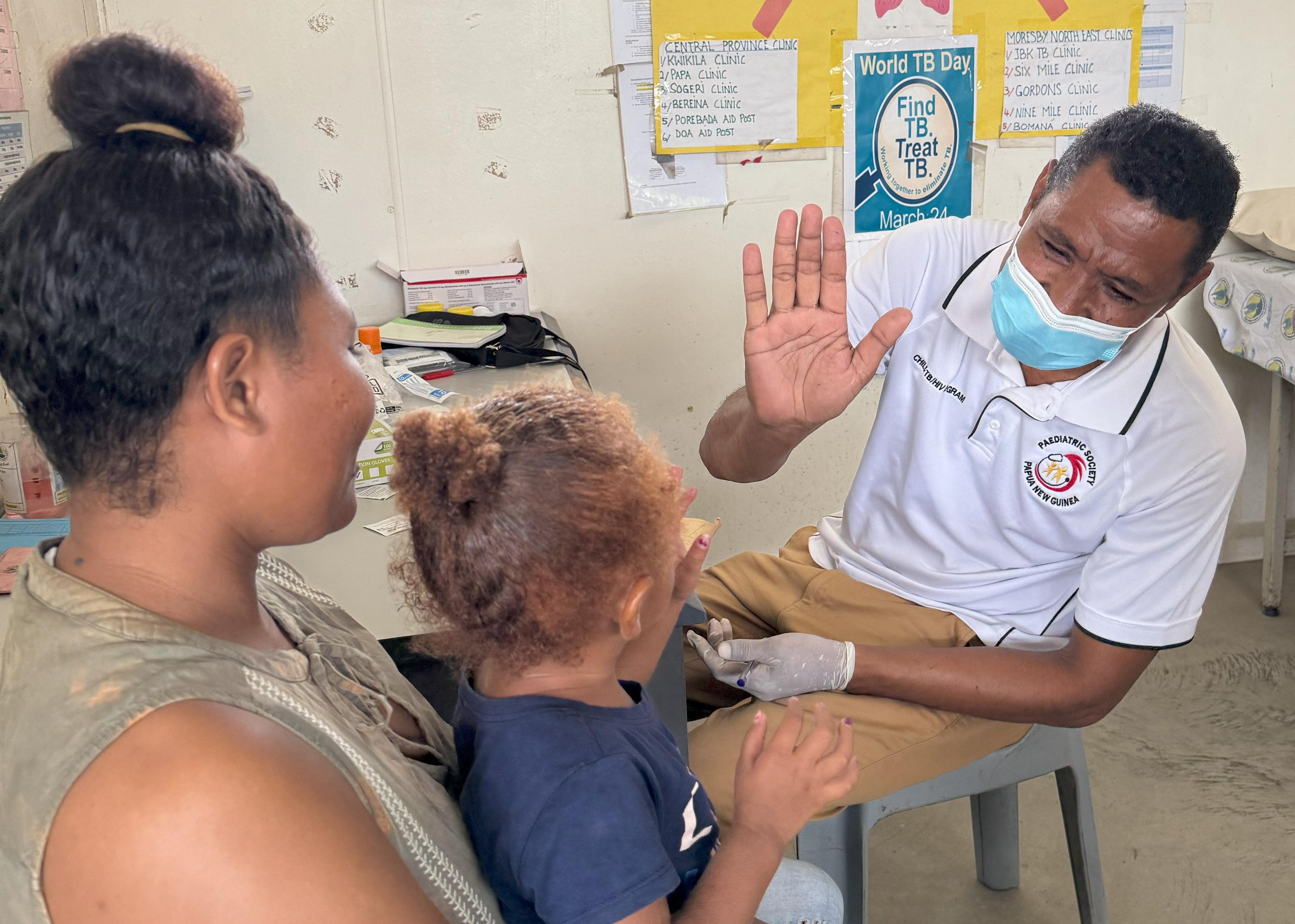 Honeu Bomiringke giving a high five to a nursing officer