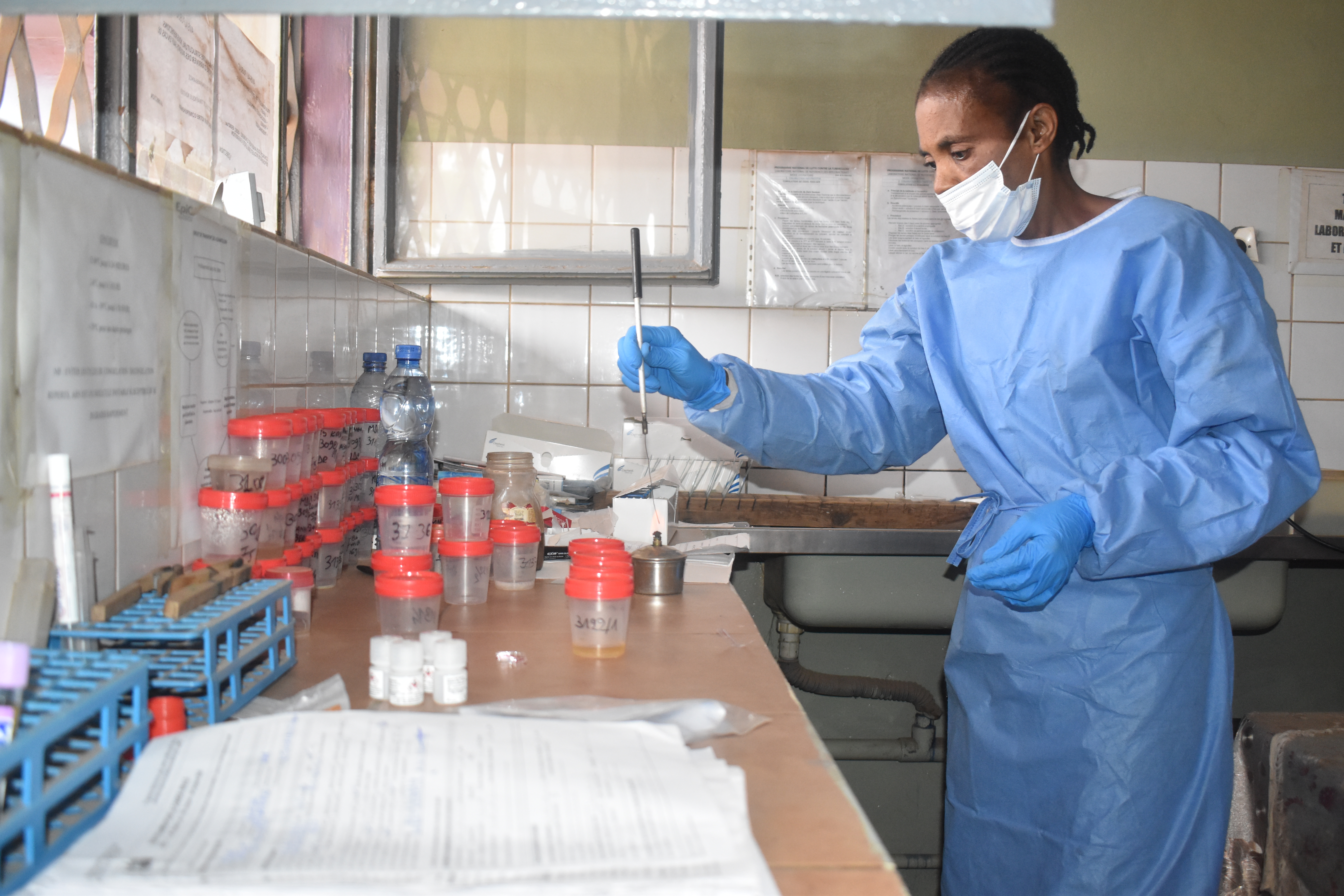 medical professional working with a beaker