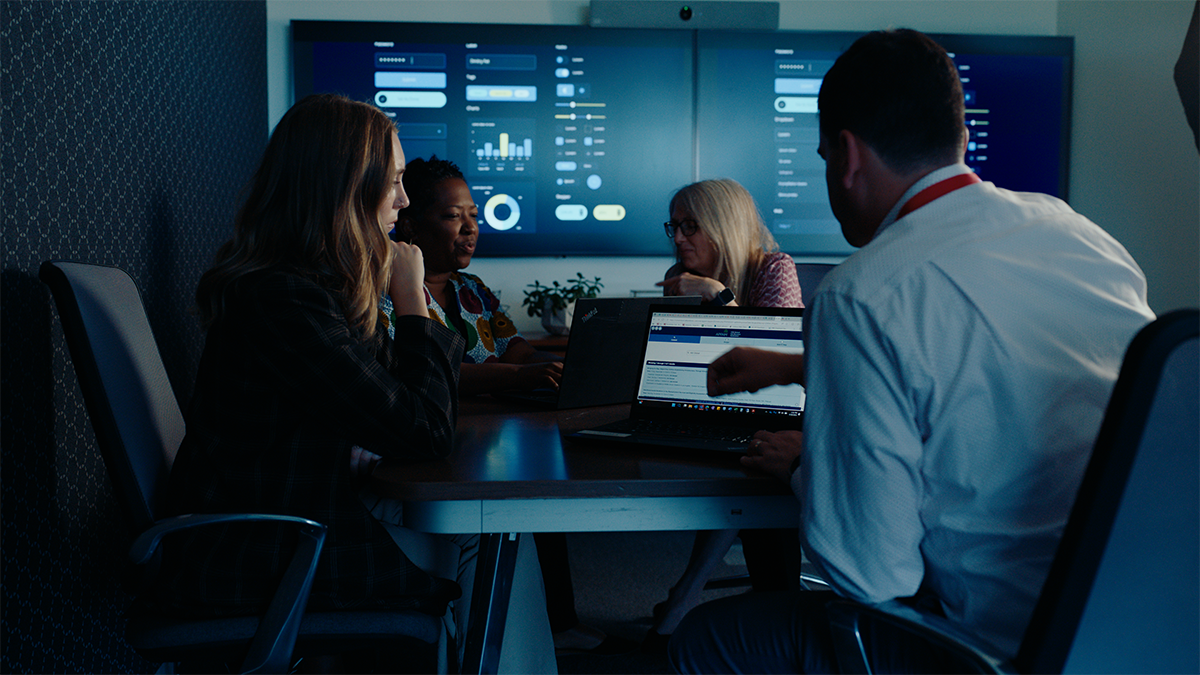 colleagues working in hi-tech conference room