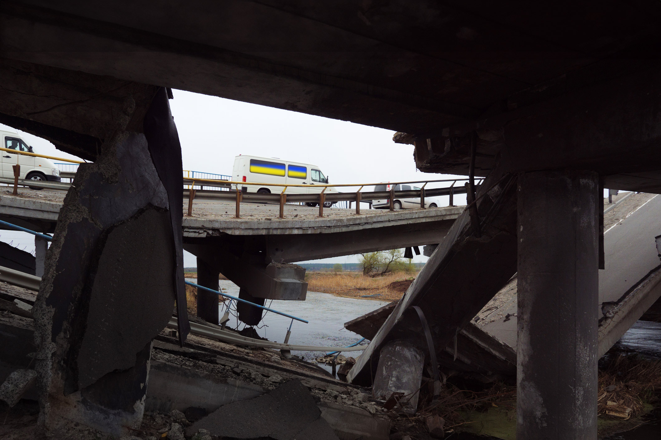 bus driving across a broken bridge