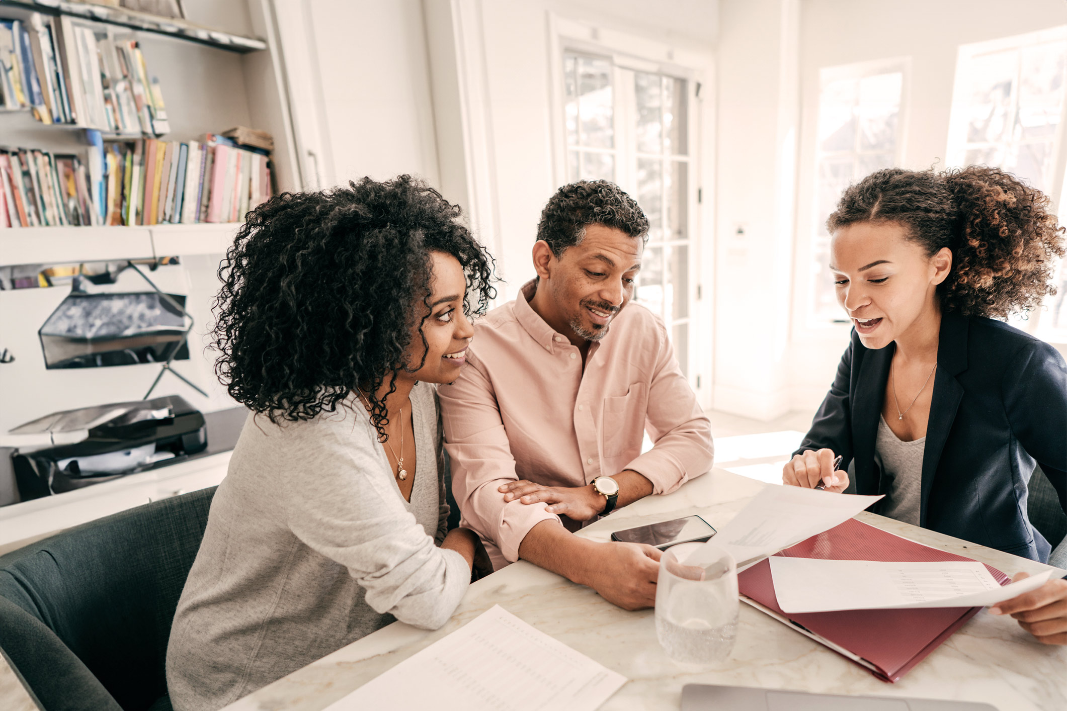 financial planner helping a smiling couple