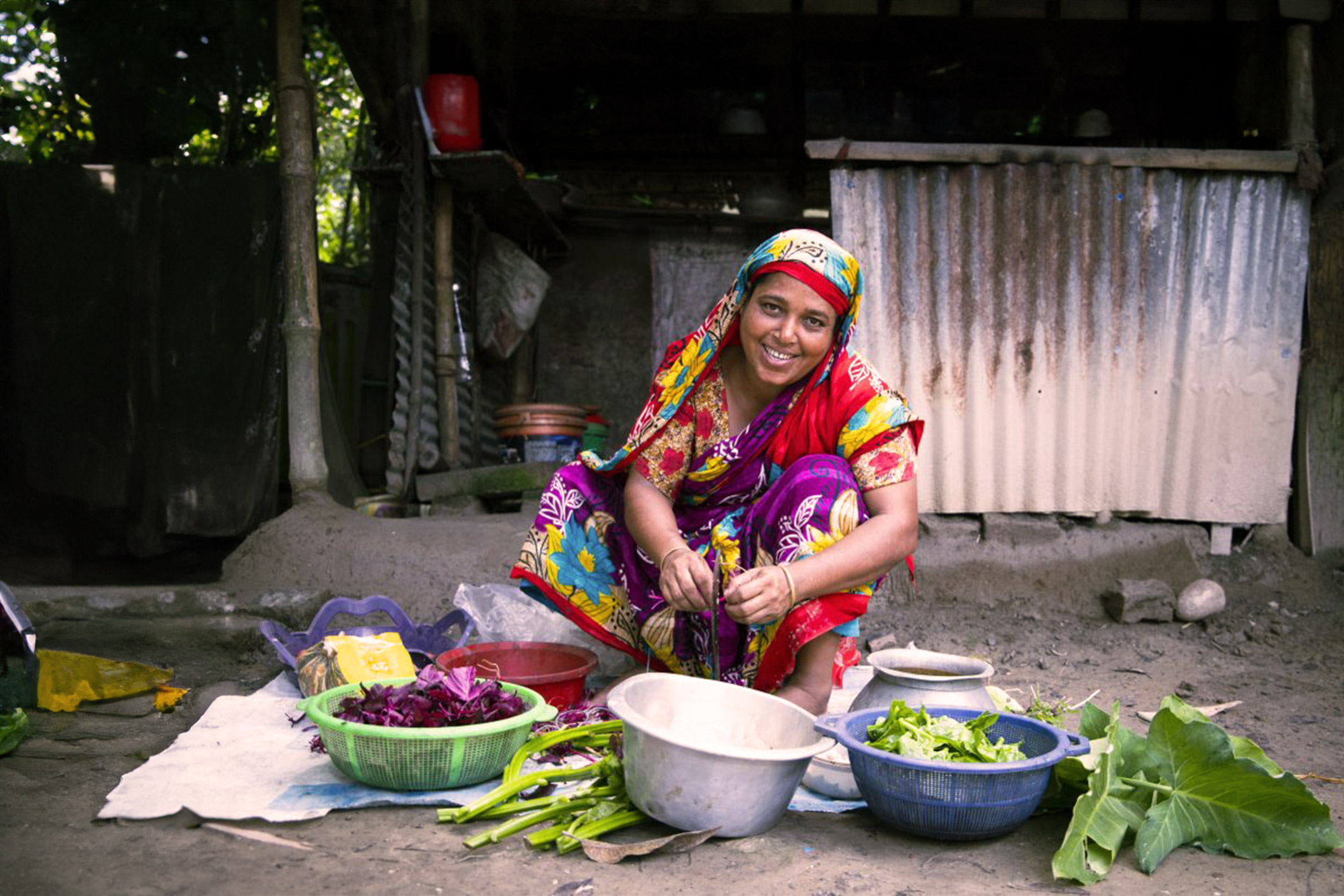 women cutting vegetables in an outdoor market