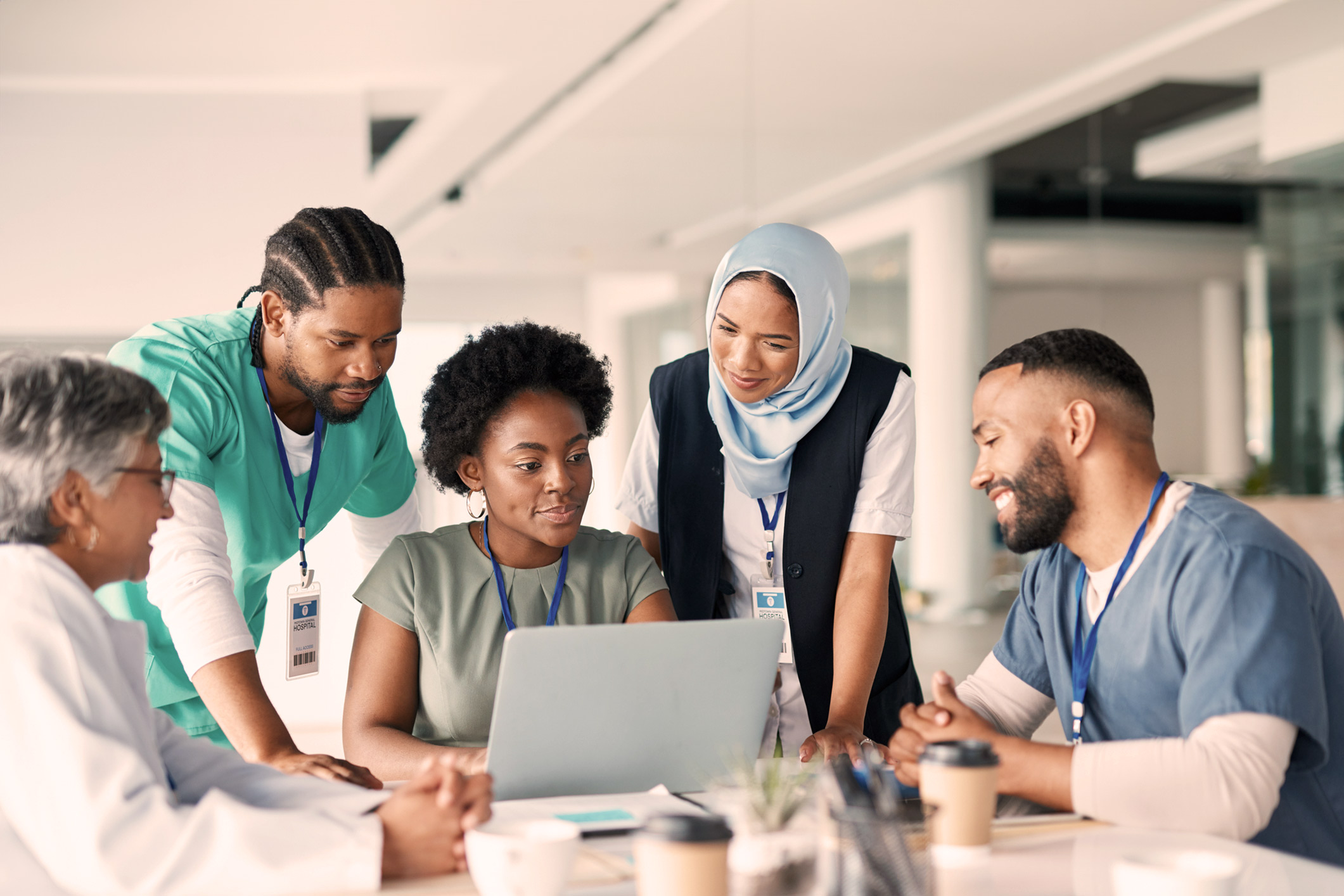 POC medical professionals gathered around a laptop