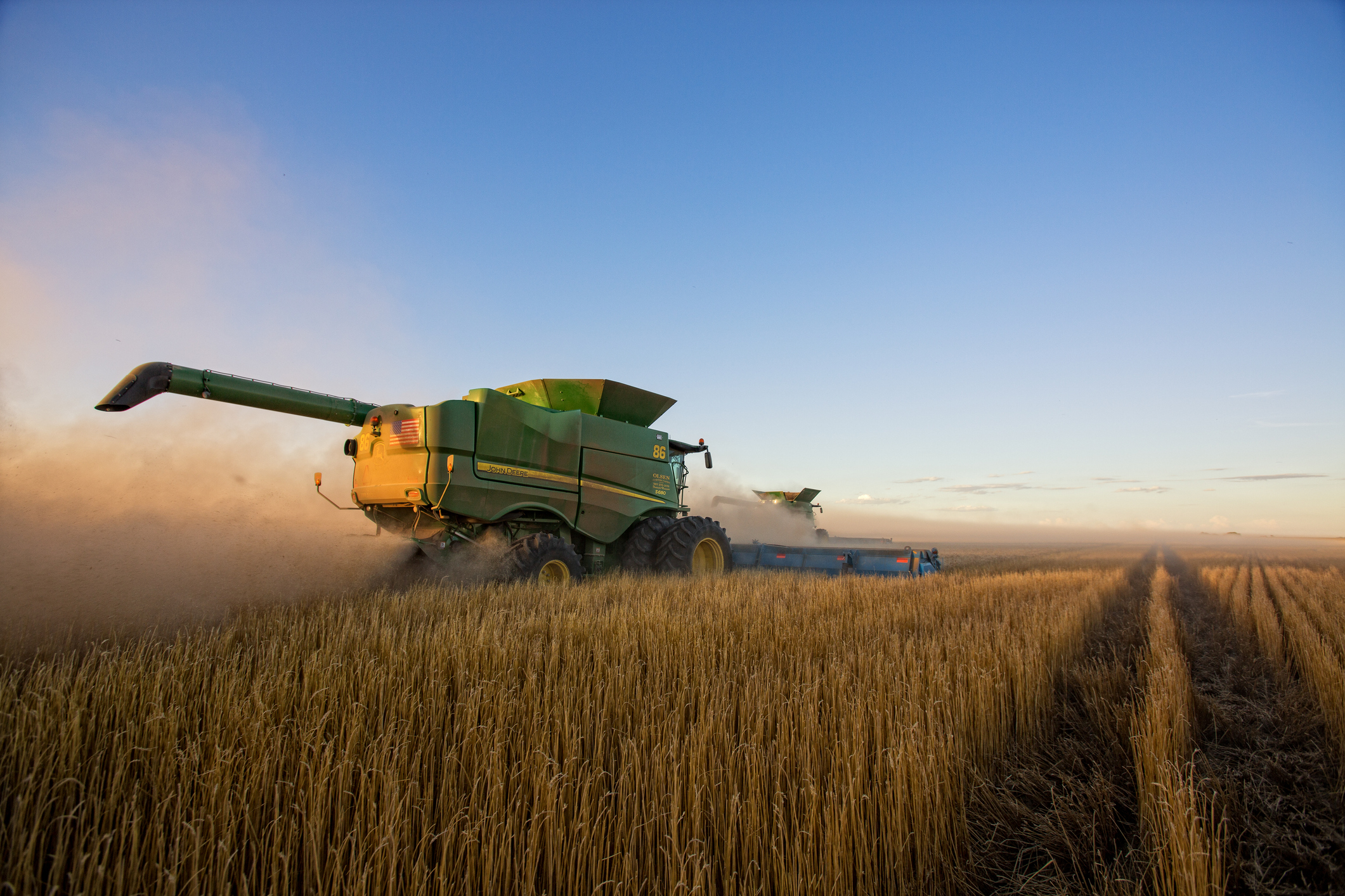 Kansas wheat farming equipment at work during the first wheat harvest