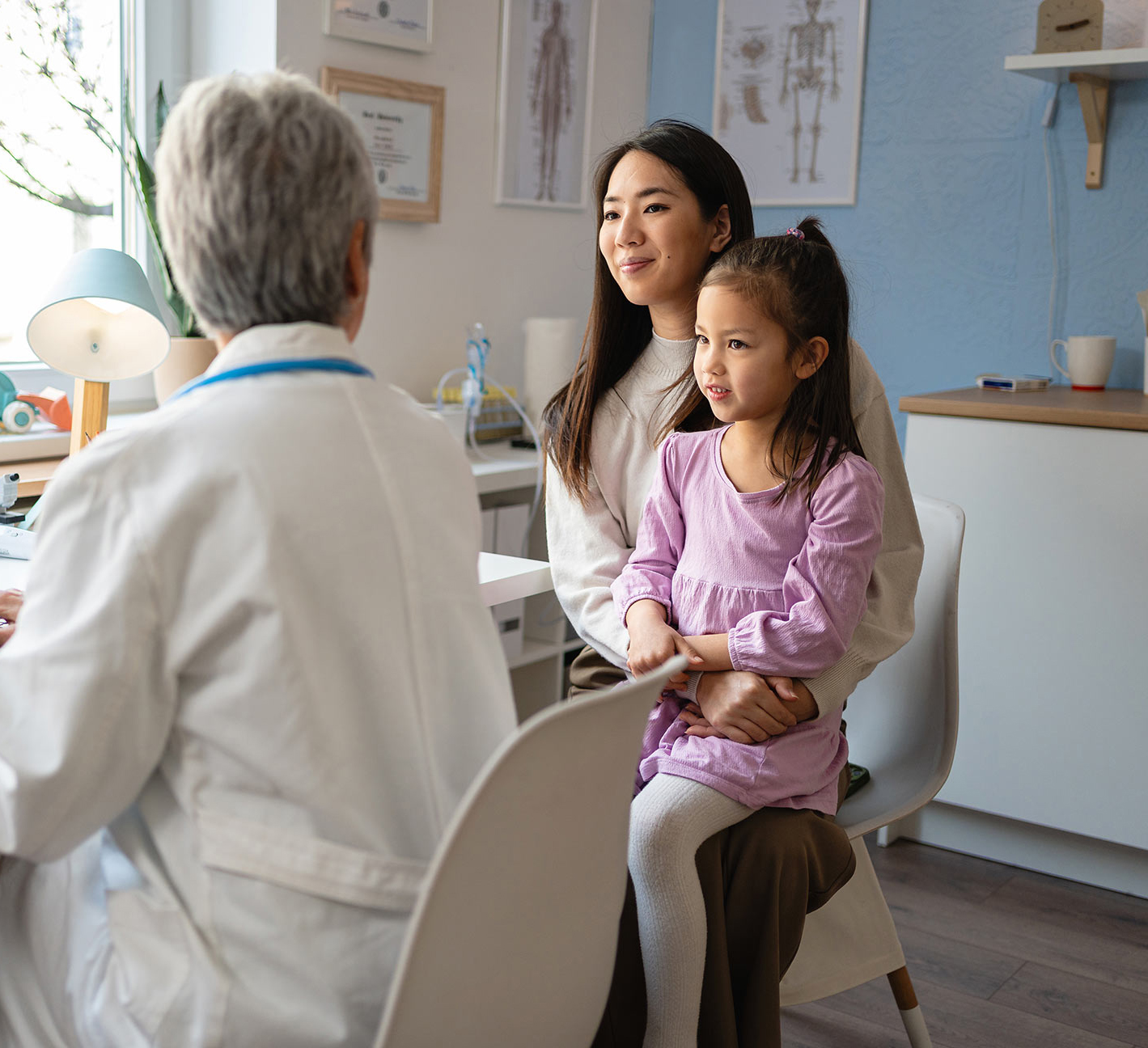 doctor talking to mother and daughter
