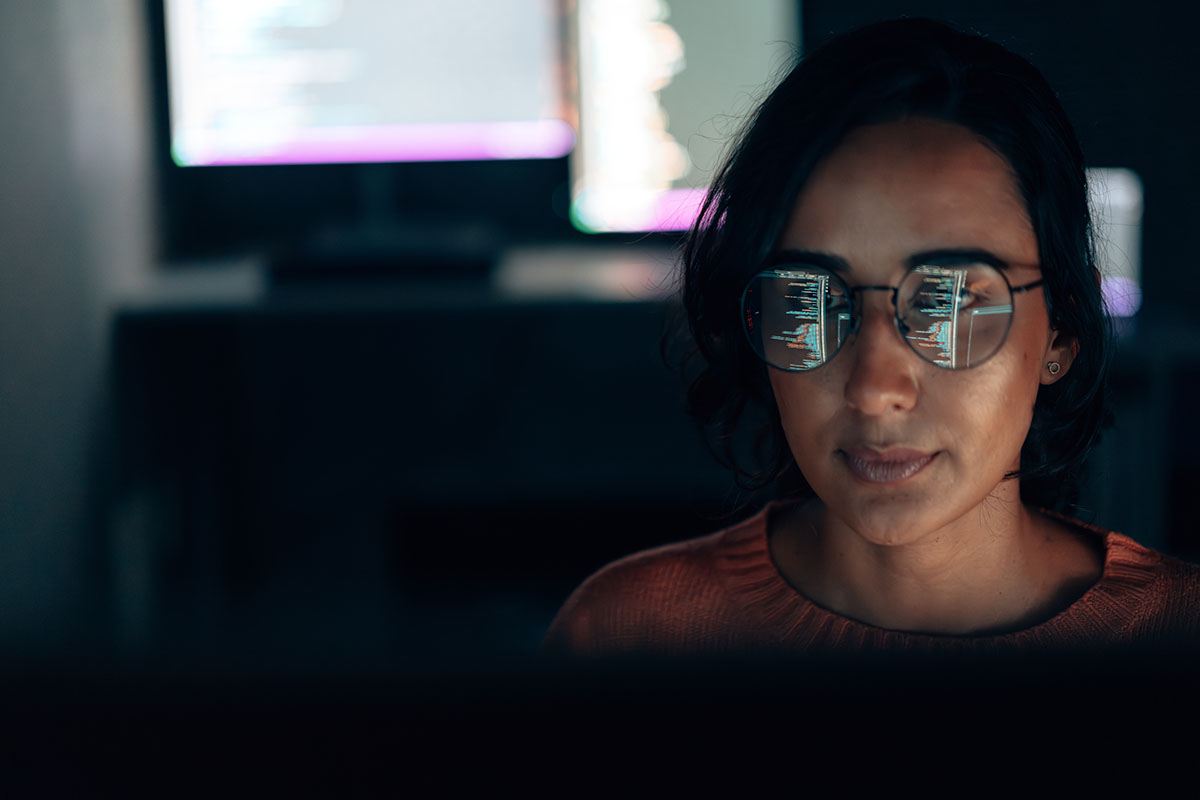 artistic image of computer graphics reflected in a woman's glasses