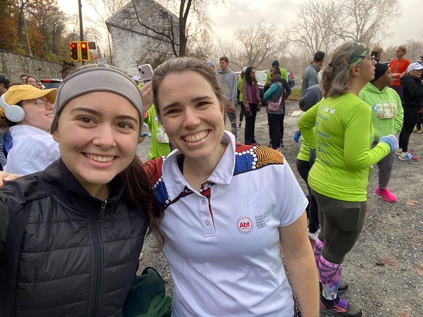 Two colleagues smiling at an outdoor volunteer event