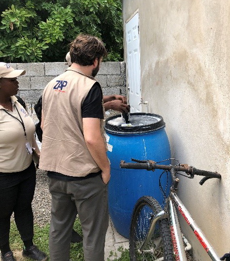 Figure 1. Conducting research field visit to better understand the process of counting mosquito eggs. Field work in Jamaica.