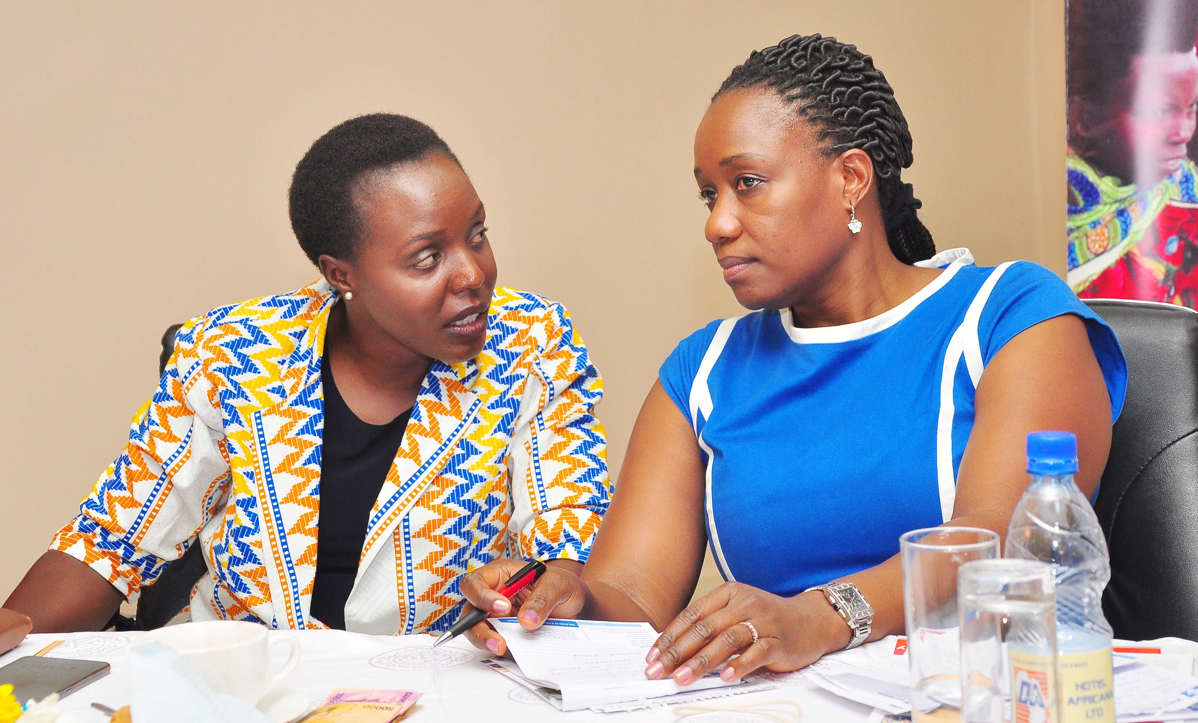 Uganda Women Parliamentary Association (UWOPA) Chairperson Monicah Amoding speakers with Uganda Voucher Plus Chief of Party Christine Namayanja