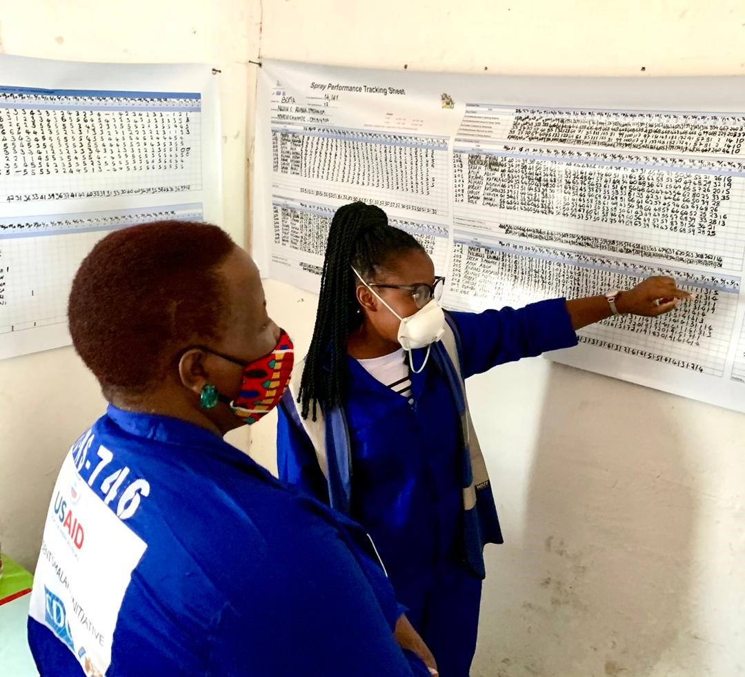 Malawi Minister of Health Khumbize Kandodo (left) listens as VL Site Manager, Nellie Ruben, explains the Spray Performance Tracker Data. Malawi Minister of Health Khumbize Kandodo (left) listens as VL Site Manager, Nellie Ruben, explains the Spray Performance Tracker Data.