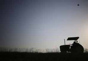 silhouette of a tractor in a field