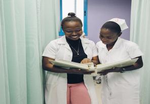 two medical professionals talking over data