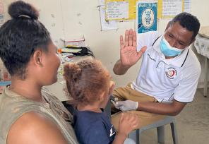 young girl giving a high five to nursing officer