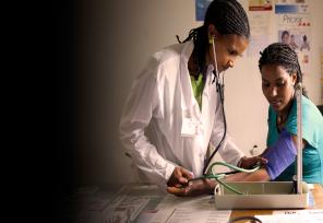 doctor taking patient's blood pressure