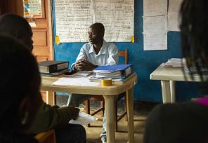 instructor sitting in front of a classroom in DRC