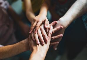 artistic view of hands on top of other hands