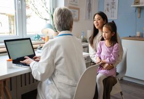 doctor talking to a mother and her daughter