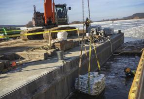a diver at Lock and Dam 4 prepares to place sandbags at the bottom of the concrete forms