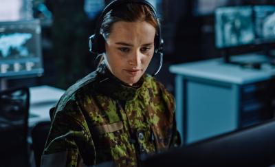Military Surveillance Officer in Headset Working in Central Office Hub for Cyber Operations