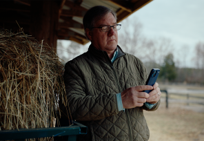 chris long on his farm looking at his phone
