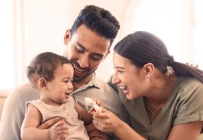mother and father with smiling baby