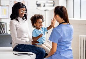 doctor talking to a mother and child