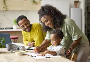 Mother teaching drawing to toddler son at home
