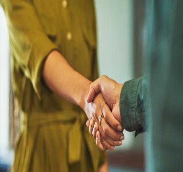 Two women shaking hands