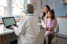 doctor talking to a mother and her daughter