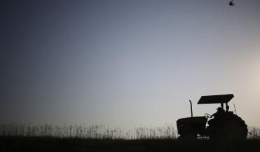 silhouette of a tractor in a field
