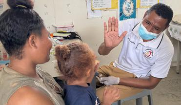 young girl giving a high five to nursing officer