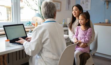 doctor talking to a mother and her daughter
