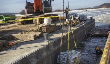 a diver at Lock and Dam 4 prepares to place sandbags at the bottom of the concrete forms