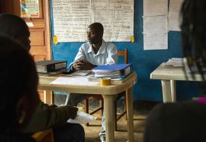 Teacher listening intently in African classroom