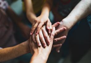 Children's hands clasped one on top of the other